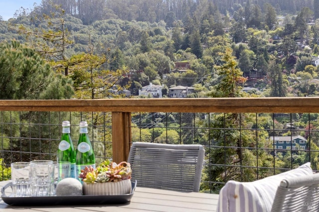 balcony featuring a view of trees