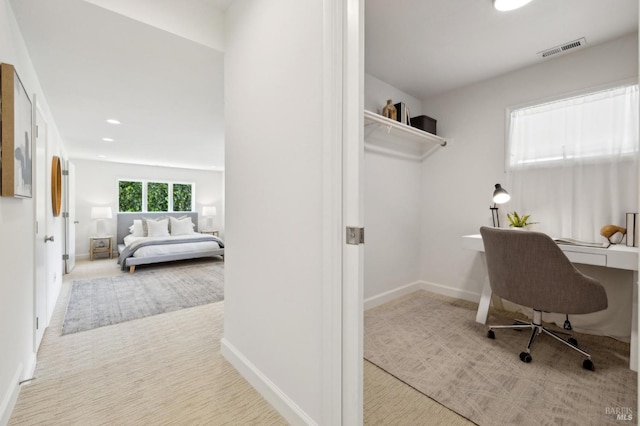 office space with visible vents, baseboards, and carpet floors