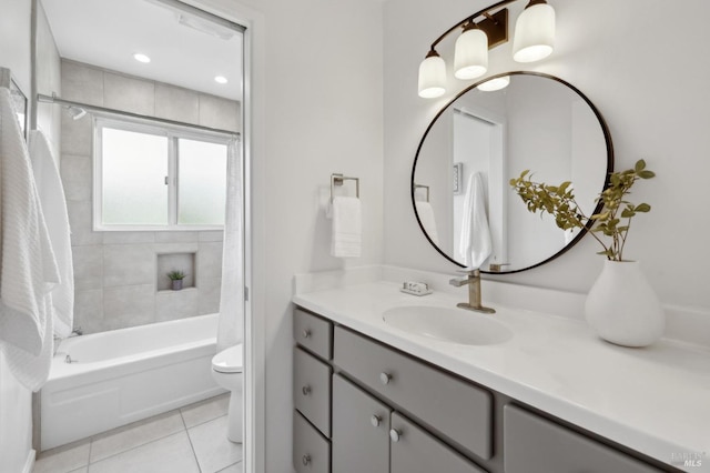 full bathroom with tile patterned flooring, shower / bathtub combination with curtain, vanity, and toilet