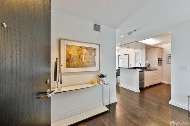 229 Brannan St Unit 12C, San Francisco, CA 94107 - kitchen featuring dark wood-style floors, dark countertops, recessed lighting, baseboards, and appliances with stainless steel finishes