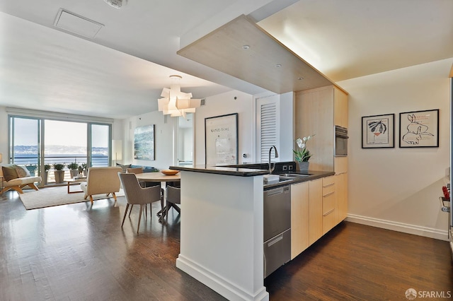 229 Brannan St Unit 12C, San Francisco, CA 94107 - kitchen with a peninsula, stainless steel dishwasher, modern cabinets, open floor plan, and dark wood-style floors