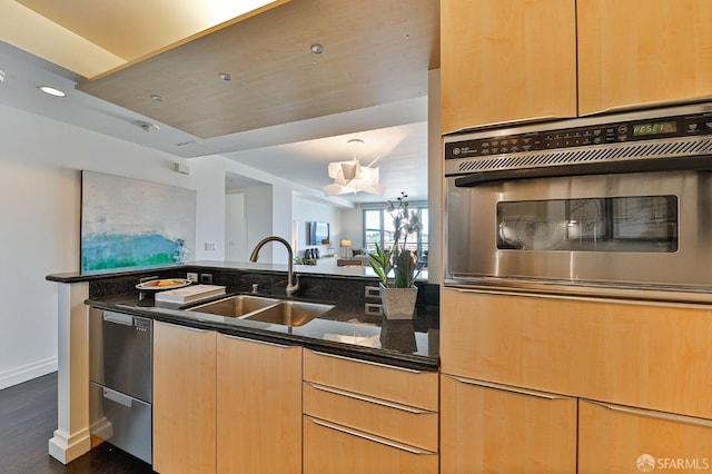 229 Brannan St Unit 12C, San Francisco, CA 94107 - kitchen featuring stainless steel appliances, a sink, dark stone countertops, dark wood-type flooring, and light brown cabinets
