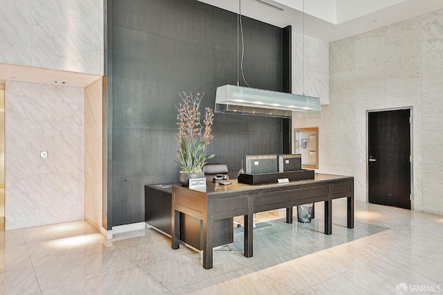 229 Brannan St Unit 12C, San Francisco, CA 94107 - home office with tile walls, a high ceiling, and marble finish floors