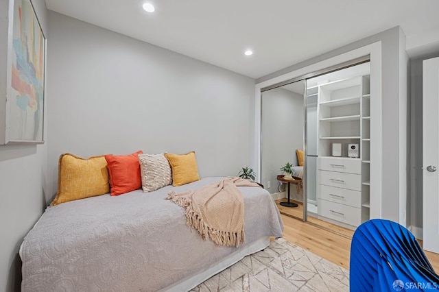 bedroom featuring light hardwood / wood-style floors and a closet