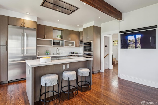61 Homestead St, San Francisco, CA 94114 - kitchen featuring built in appliances, dark wood finished floors, light countertops, a breakfast bar, and open shelves