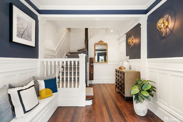 interior space featuring a decorative wall, dark wood-type flooring, and stairs