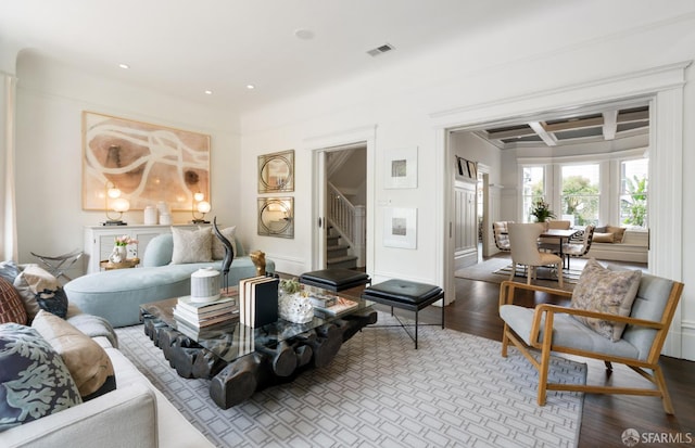 living room featuring beam ceiling, visible vents, recessed lighting, coffered ceiling, and stairs