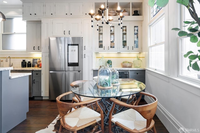 dining room with dark wood-type flooring, beverage cooler, and a chandelier