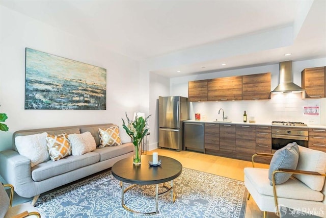 living room featuring light wood-type flooring, wet bar, and recessed lighting