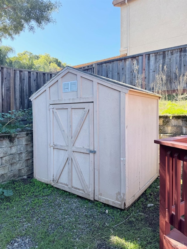 view of shed featuring fence