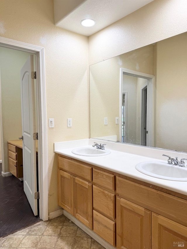 full bathroom featuring a sink and double vanity