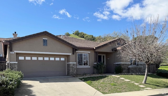 view of front of house featuring an attached garage, stone siding, driveway, and stucco siding