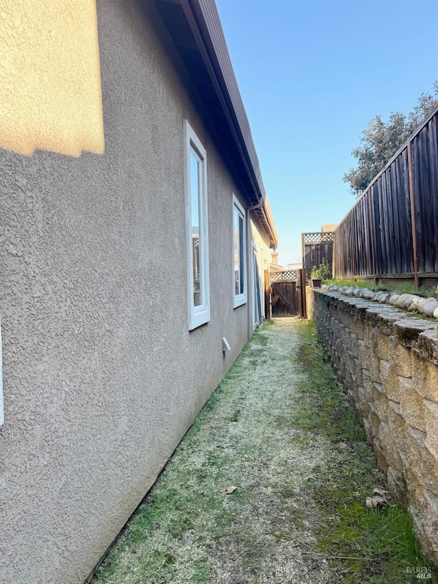 view of property exterior featuring a fenced backyard and stucco siding