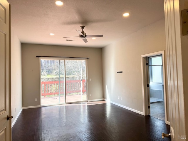 spare room featuring dark wood-style floors, recessed lighting, and baseboards