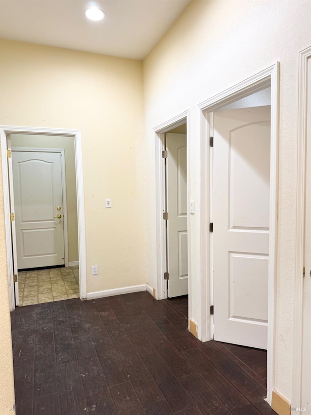 hall with recessed lighting, hardwood / wood-style flooring, and baseboards