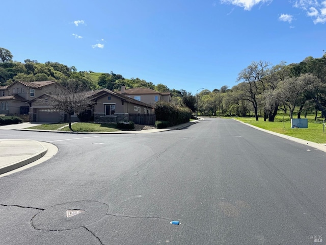 view of road with sidewalks and curbs