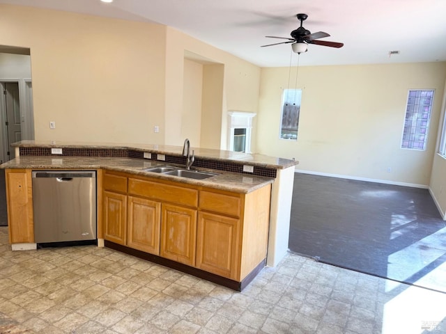 kitchen with a sink, baseboards, open floor plan, stainless steel dishwasher, and light floors