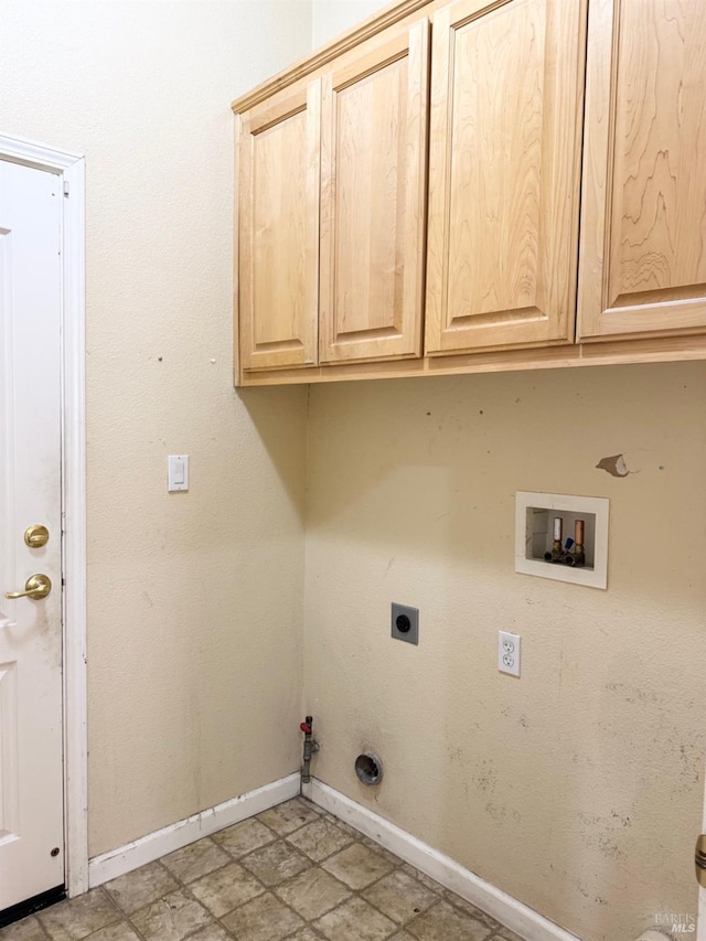 laundry room with hookup for a washing machine, cabinet space, gas dryer hookup, electric dryer hookup, and baseboards