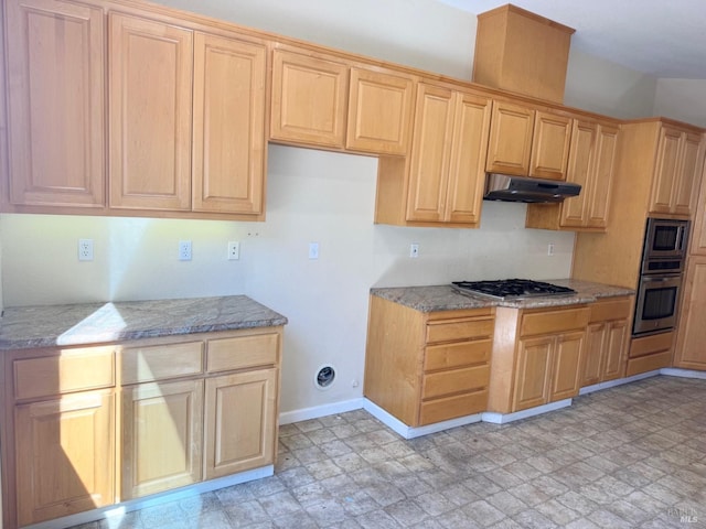 kitchen with appliances with stainless steel finishes, light floors, light stone countertops, under cabinet range hood, and light brown cabinets