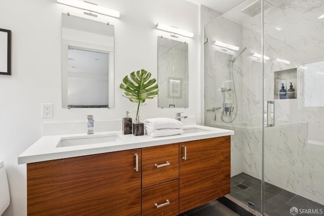 bathroom with vanity, toilet, and a shower with shower door