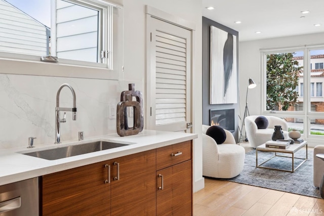 kitchen featuring sink, light hardwood / wood-style floors, and dishwasher