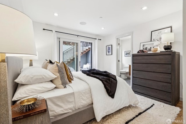 bedroom featuring connected bathroom, hardwood / wood-style floors, and access to exterior