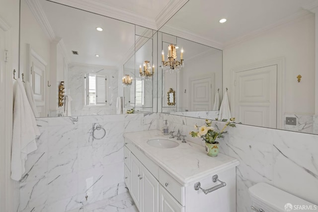 bathroom featuring an inviting chandelier, tile walls, vanity, ornamental molding, and toilet