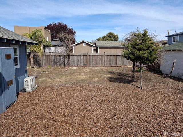 view of yard with a fenced backyard and ac unit