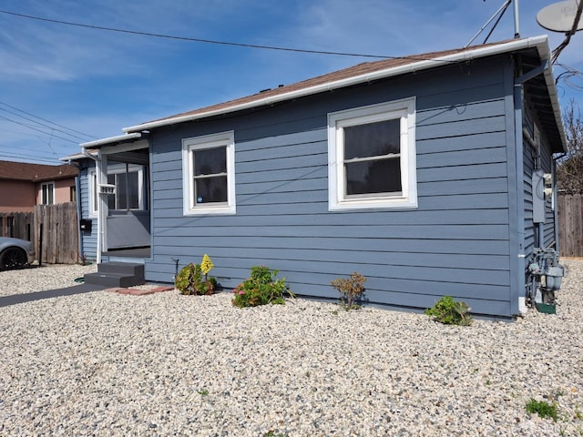 bungalow-style home with entry steps and fence