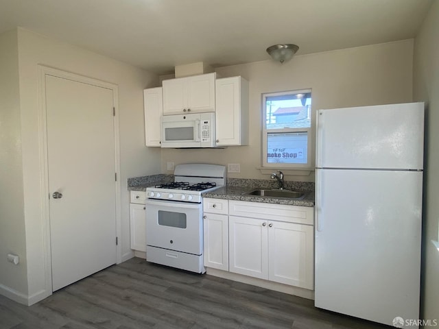 kitchen with a sink, white cabinets, white appliances, stone countertops, and dark wood-style flooring