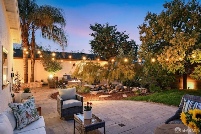 patio terrace at dusk featuring outdoor lounge area