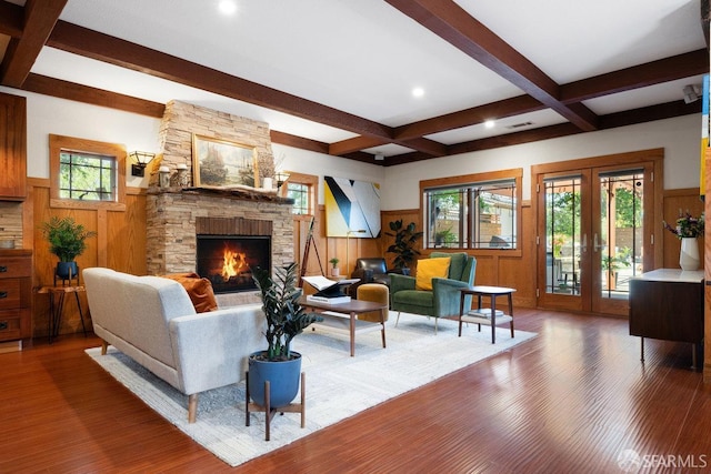 living room with french doors, a fireplace, wainscoting, beam ceiling, and wood finished floors