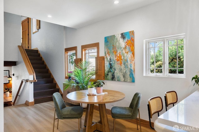 dining space featuring recessed lighting, light wood finished floors, and stairway