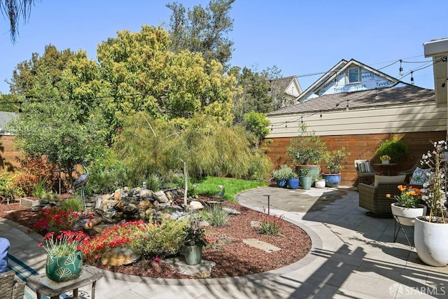 view of yard featuring fence and a patio area