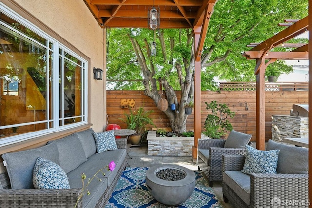 view of patio featuring fence and an outdoor living space with a fire pit