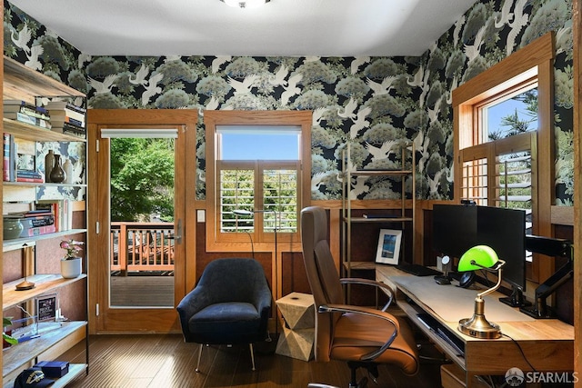 office space with a healthy amount of sunlight, wallpapered walls, and wood finished floors