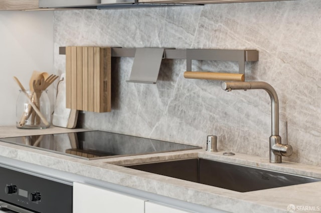 kitchen featuring dishwasher, backsplash, and white cabinets