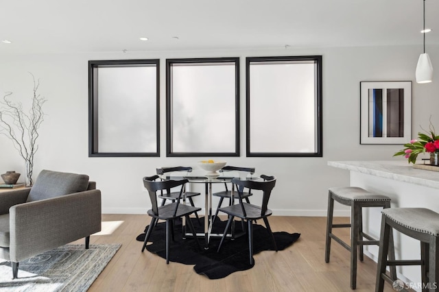 dining space with light hardwood / wood-style flooring