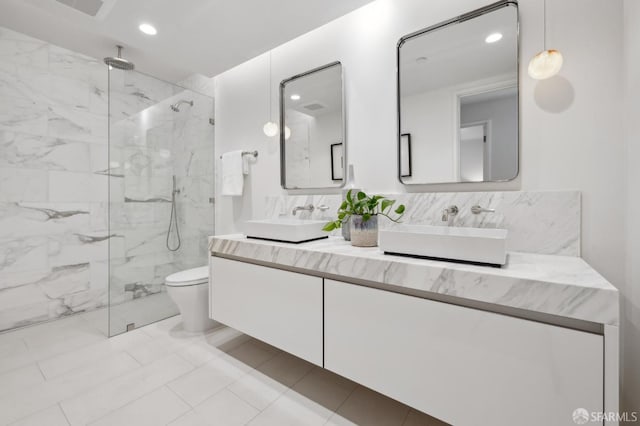 bathroom featuring toilet, vanity, and walk in shower