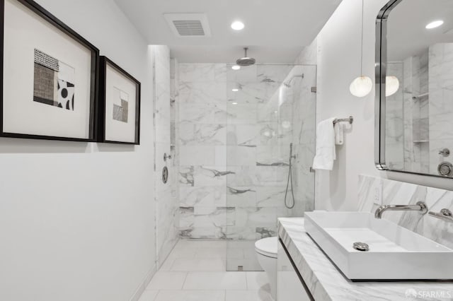 bathroom with walk in shower, sink, and toilet