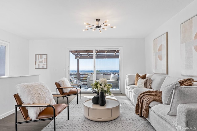 living room featuring a notable chandelier and light wood-type flooring