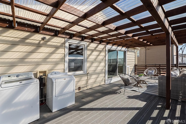 deck with a pergola and washing machine and clothes dryer