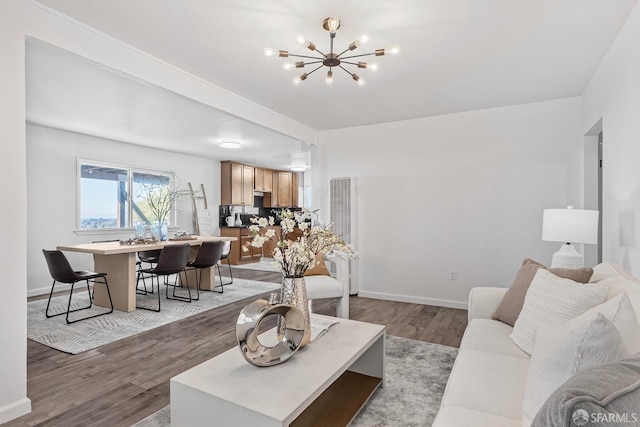 living room with an inviting chandelier and light hardwood / wood-style flooring