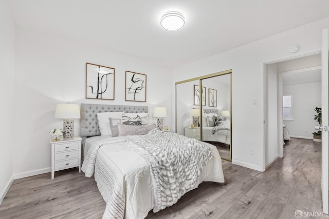 bedroom featuring light hardwood / wood-style floors and a closet