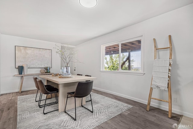 dining space with hardwood / wood-style flooring