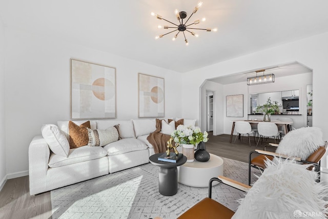 living room with an inviting chandelier and hardwood / wood-style flooring