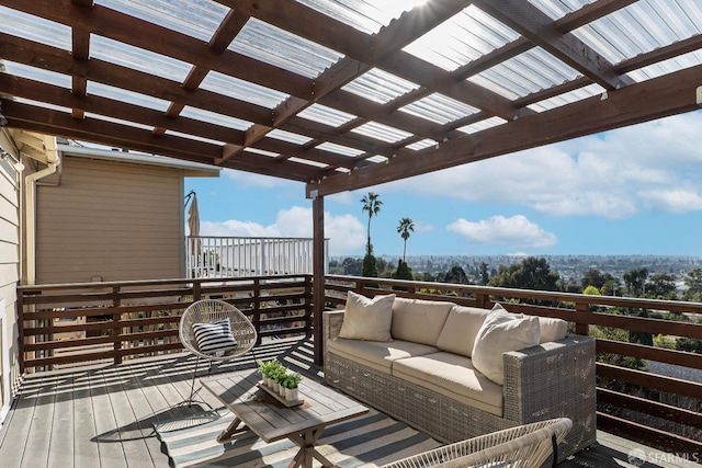 wooden terrace with an outdoor living space and a pergola