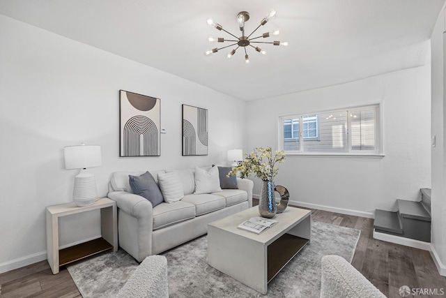 living room with hardwood / wood-style flooring and a notable chandelier