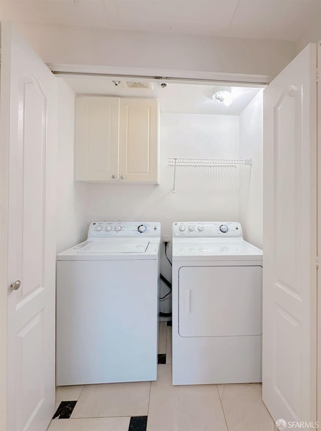 1951 Ofarrell St Unit 420, San Mateo, CA 94403 - laundry room with cabinet space, washer and dryer, and light tile patterned floors