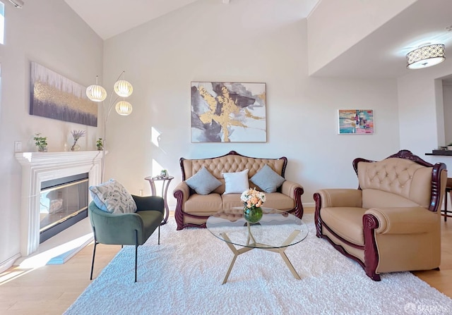 1951 Ofarrell St Unit 420, San Mateo, CA 94403 - living room with wood finished floors, a glass covered fireplace, and vaulted ceiling